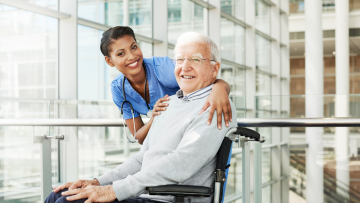 man in wheelchair with a nurse