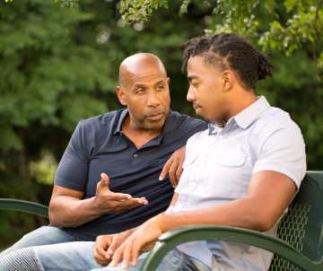 and older man giveing advice to a younger man