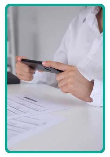 A person taking a photo of a document with a cell phone